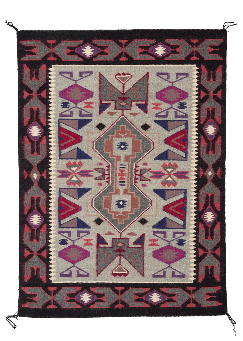A Navajo Teec Nos Pos rug Late 20th century, Dine, attributed to Mary King Woven in multicolored: A Navajo Teec Nos Pos rug Late 20th century, Dine, attributed to Mary King Woven in multicolored wool, with an elaborate central panel with multiple elaborate diamonds and serrated edges, and