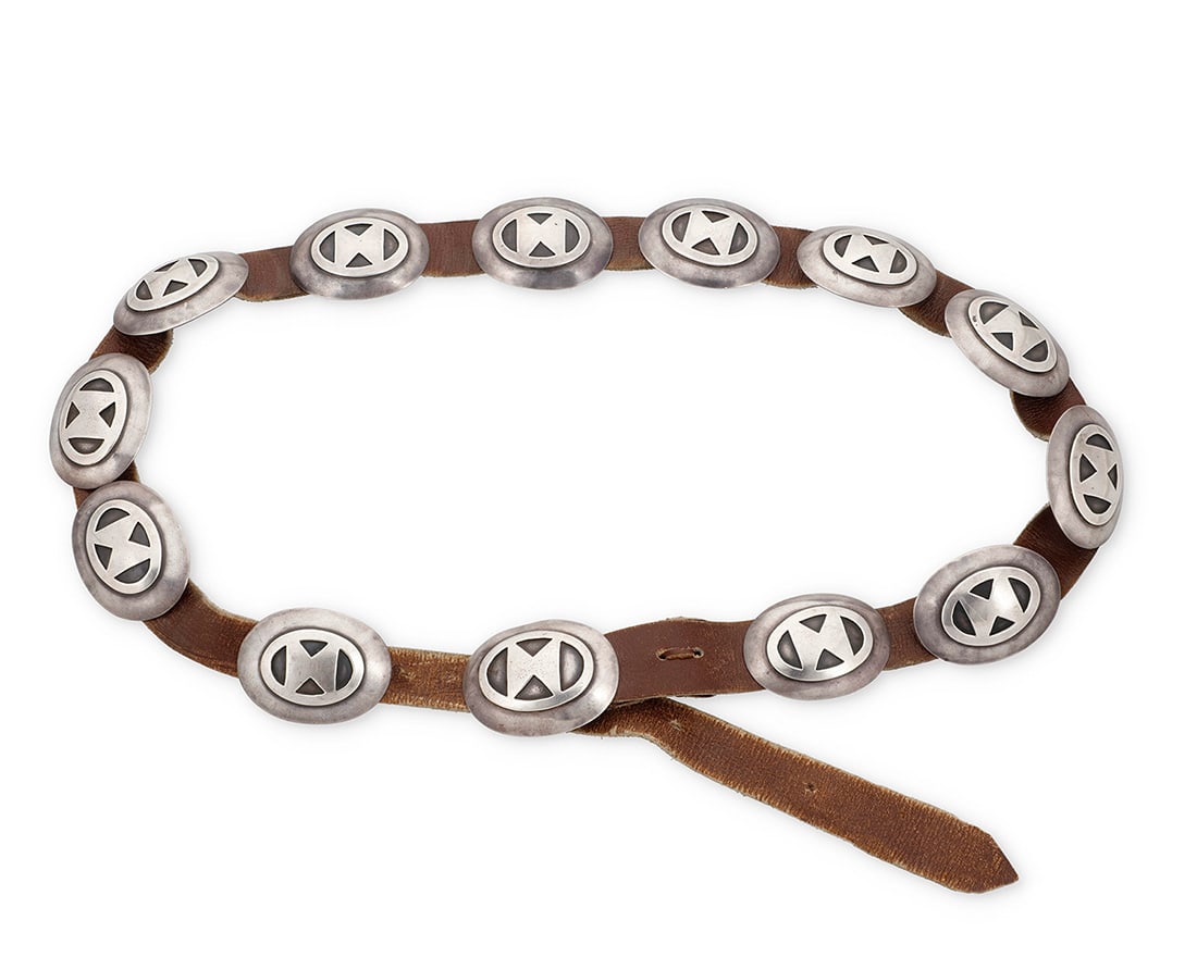 A Navajo sterling silver concho belt Mid-20th century, Dine Unmarked Comprising twelve oval (1 of 2)
