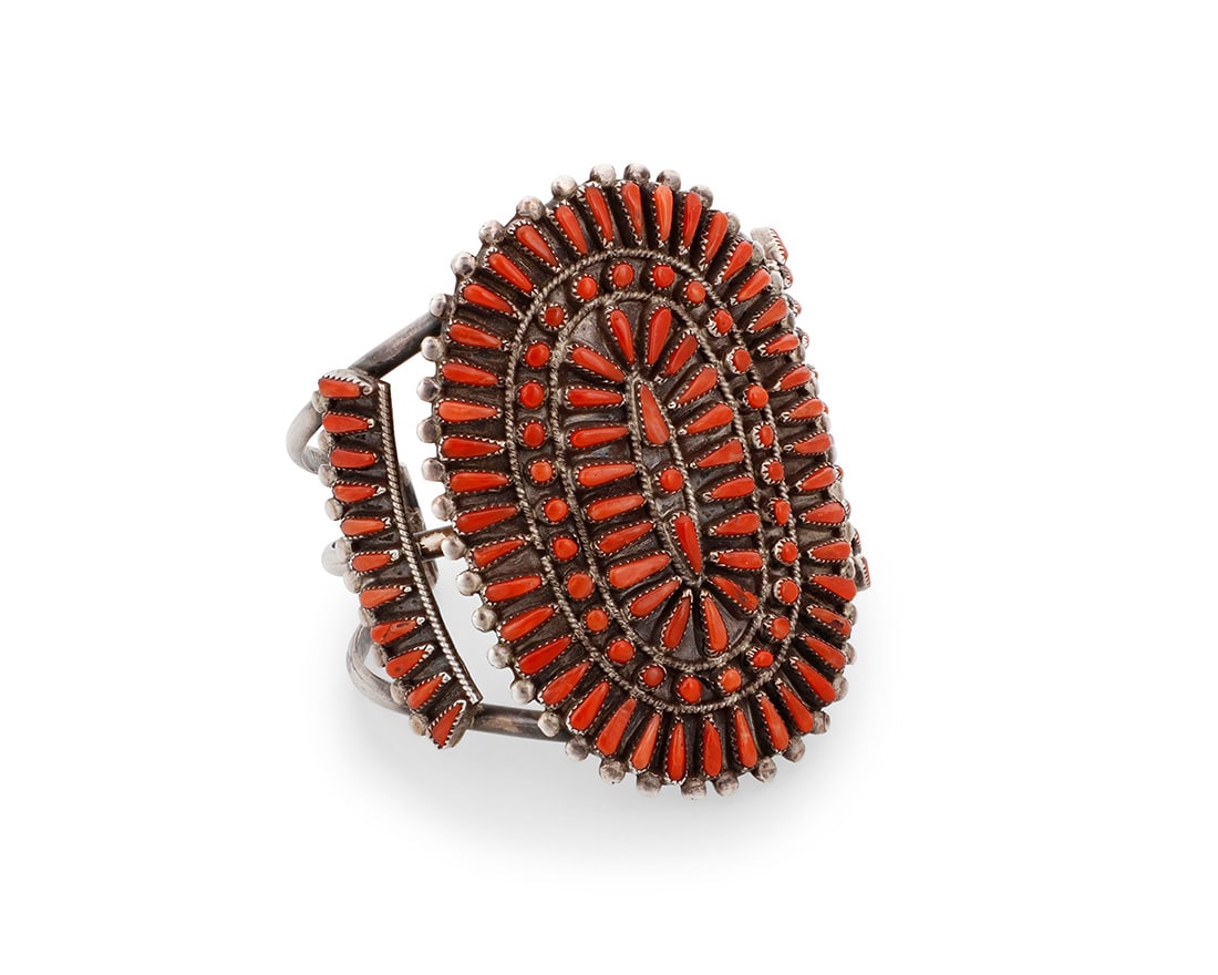 A Vernon Wallace Zuni petit point coral cuff bracelet: A Vernon Wallace Zuni petit point coral cuff braceletVernon Wallace (b. 1950, Zuni Pueblo)Late 20th centuryEtched verso: V. WallaceA sterling silver three-wire cuff with a large petit point coral clus