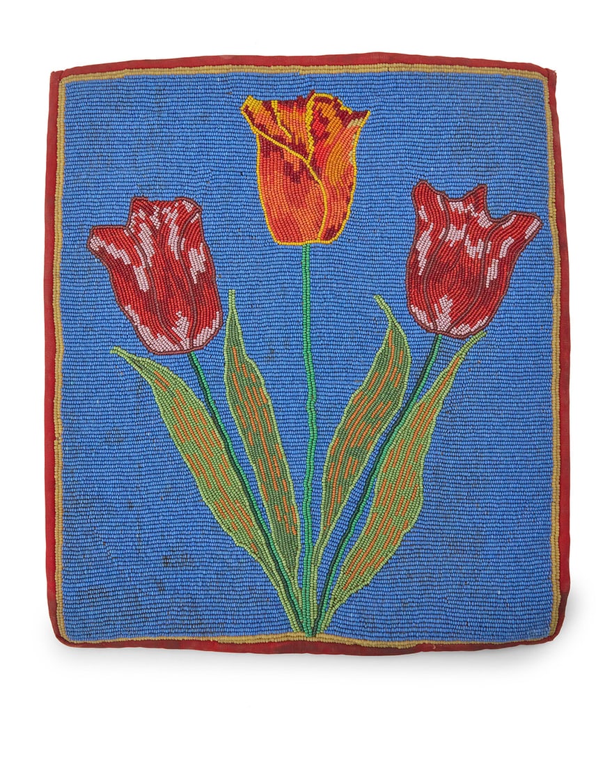 A Nez Perce/Plateau floral beaded bag: A Nez Perce/Plateau floral beaded bag Mid-20th century A rectangular bag with tulip motif on front panel in multicolored beads of red, orange, and yellow on a vivid blue field, edged with red fabric,