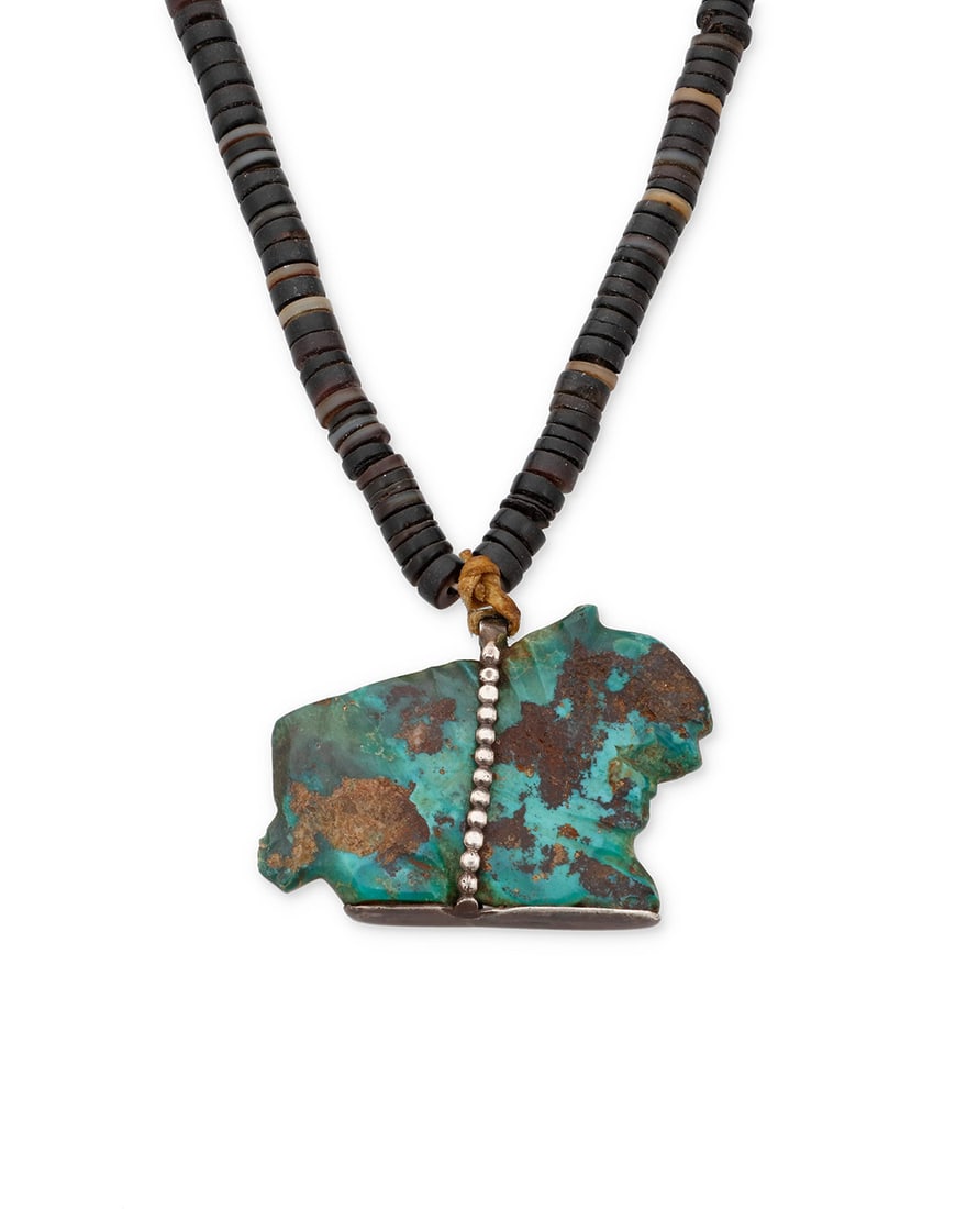 An early Southwest Pueblo turquoise fetish necklace: An early Southwest Pueblo turquoise fetish necklace Early 20th century Comprising a large carved turquoise fetish animal pendant with silver foot suspended from a single strand of sinew-strung black