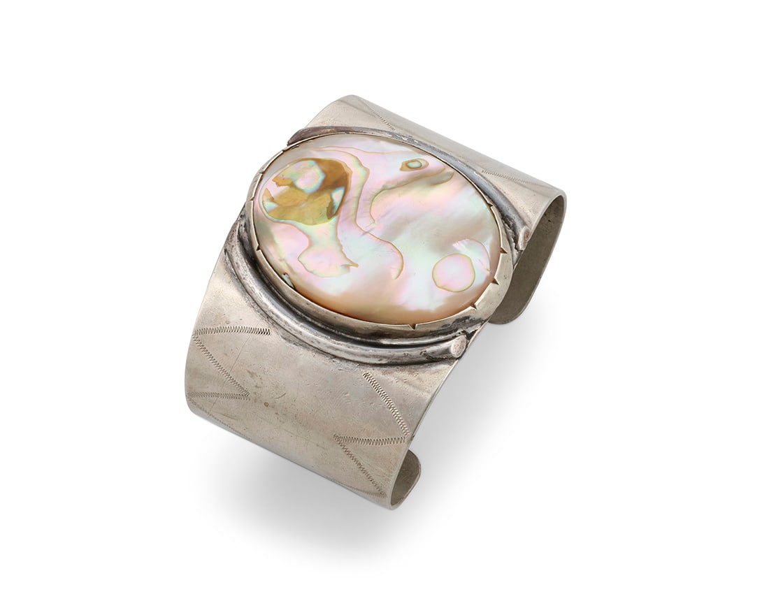 A Julius Caesar Southwest style nickel silver and abalone cuff bracelet: A Julius Caesar Southwest style nickel silver and abalone cuff bracelet Julius Caesar (1910-1982, Pawnee) Mid/late 20th century With etched signature: J Ceasar [sic] A chunky wide cuff featuring a