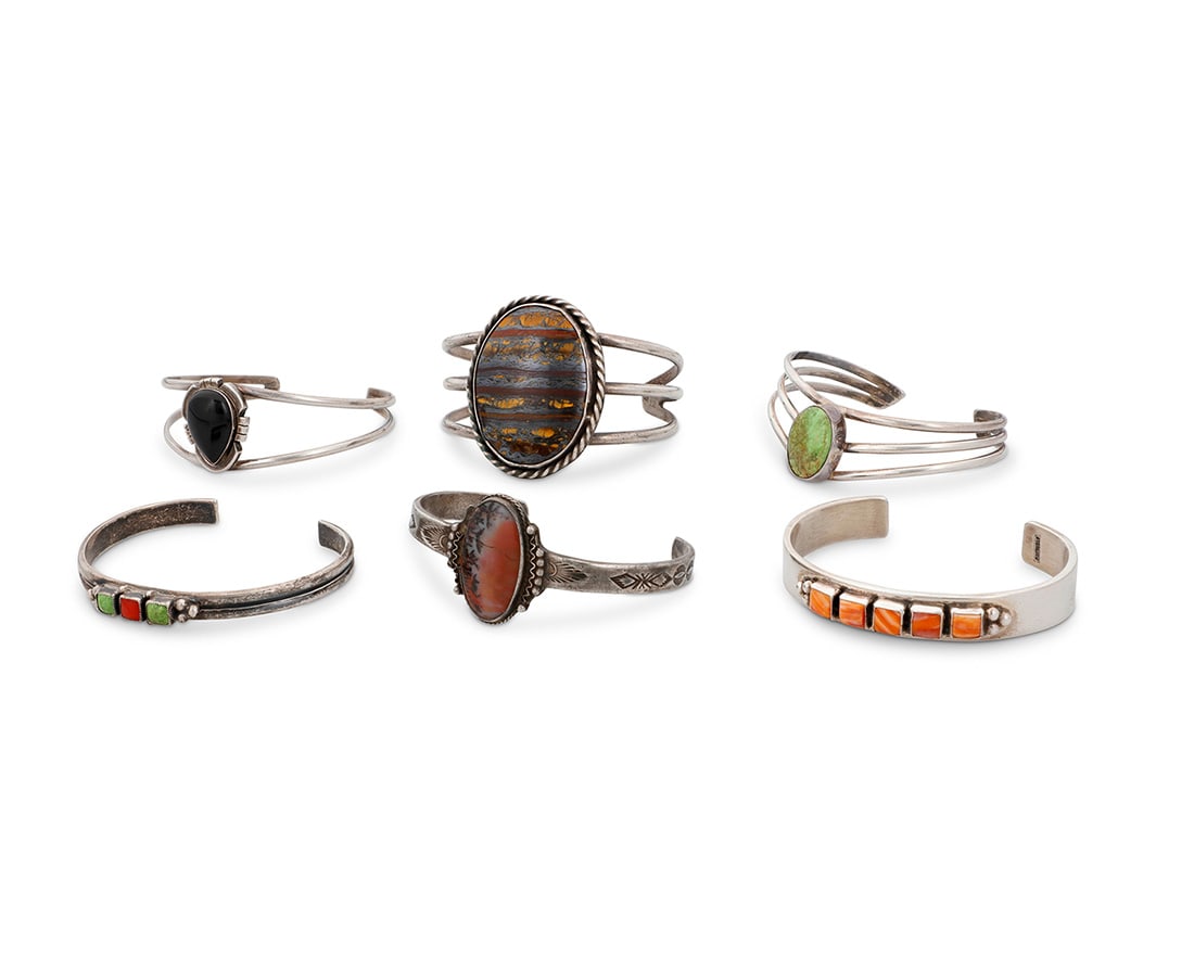 A group of Southwest style silver cuff bracelets Mid/late 20th century Four marked for sterling; (1 of 6)