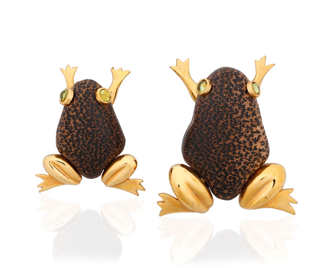 L'oree du Bois: Two Gold-Plate and Wood Brooches: L'oree du Bois: Two Gold-Plate and Wood BroochesOf a frog design featuring carved wooden bodies, gold-plated legs and finished with green glass eyes, signed L'oree du Bois, FranceMeasures: 2 1/4 x 1 3