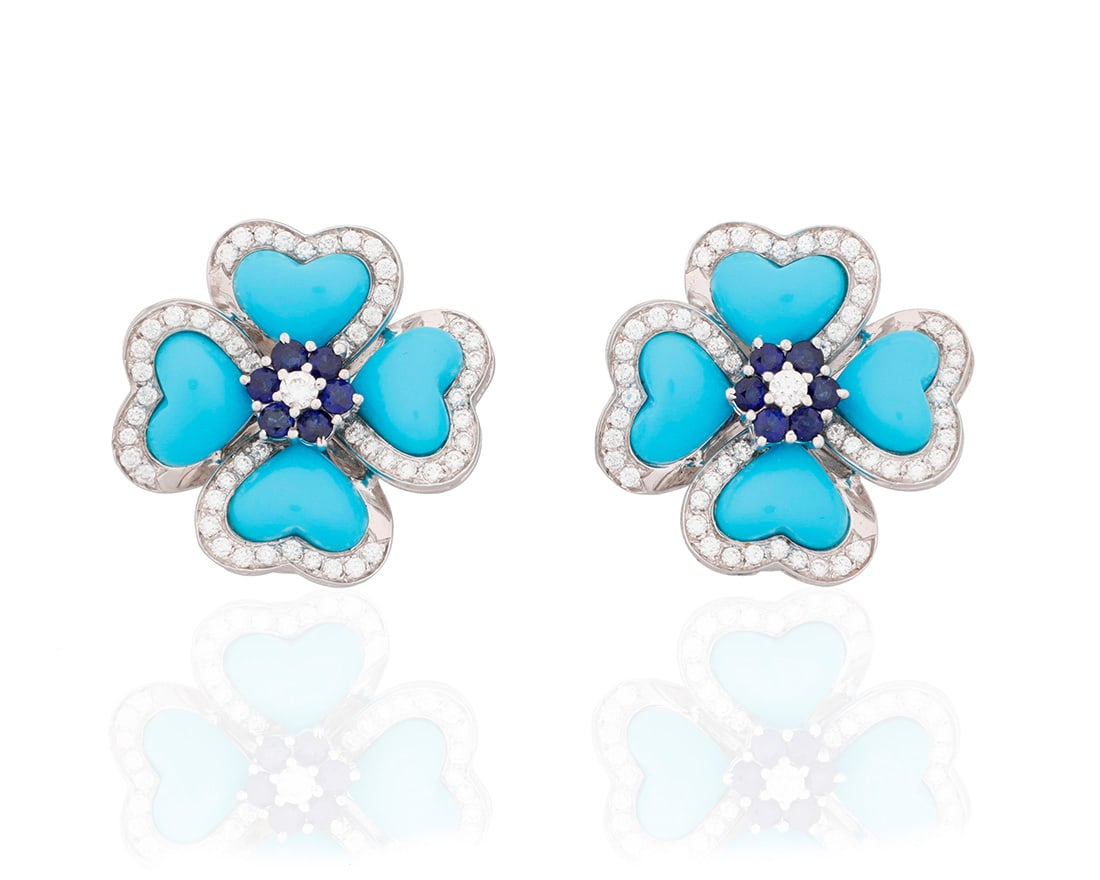 A Pair of 14K White Gold, Turquoise, Sapphire and Diamond Earclips: A Pair of 14K White Gold, Turquoise, Sapphire and Diamond EarclipsOf a floral design featuring carved turquoise petals, centering round sapphires and finished with round diamonds weighing approximatel