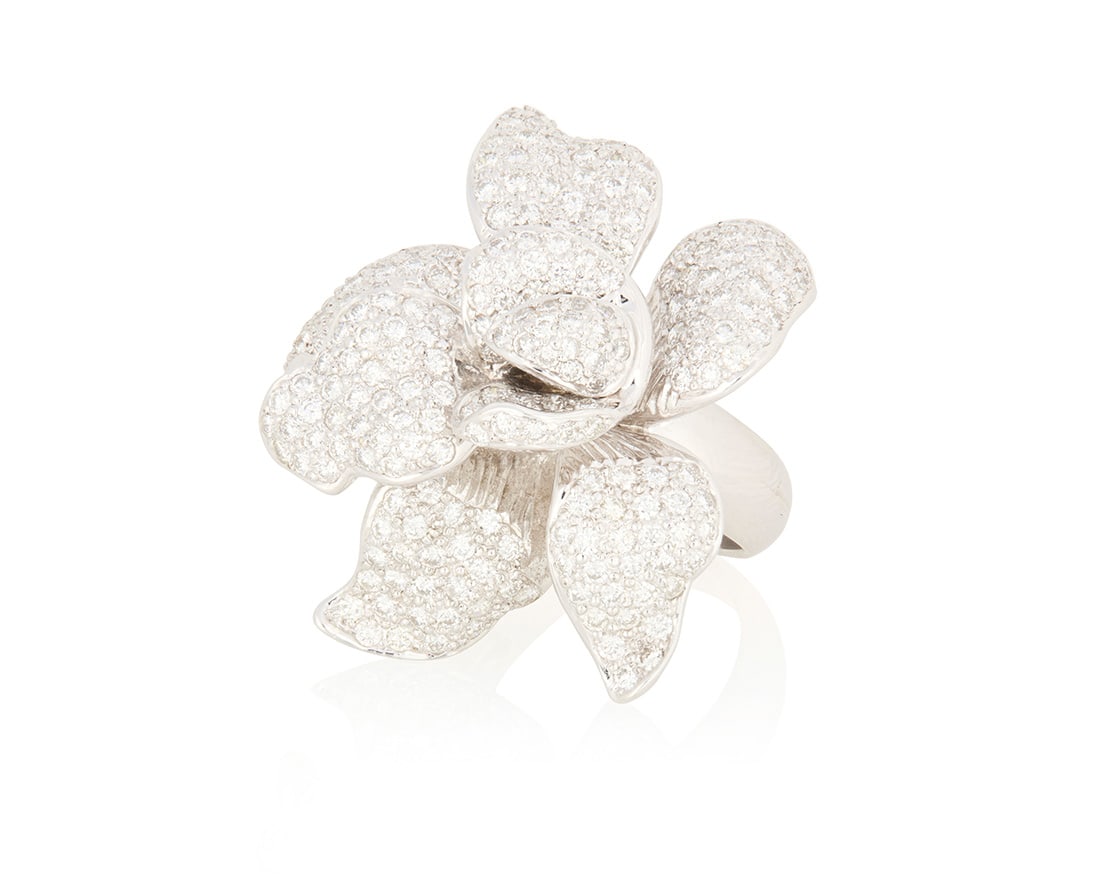 An 18K White Gold and Diamond Ring: An 18K White Gold and Diamond RingOf a dimensional floral design set with pave diamonds weighing approximately 6.50 caratsSize: 6 3/415.7 grams grossProvenance:The Estate of Joanna Carson