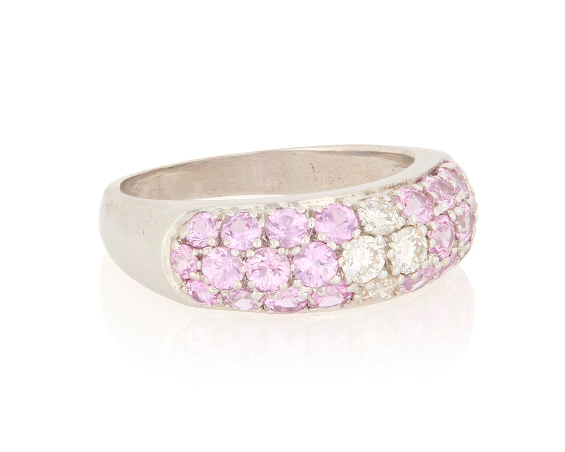 An 18K Gold, Pink Sapphire and Diamond Ring: An 18K Gold, Pink Sapphire and Diamond RingFeaturing round pink sapphires weighing approximately 2.40 carats, centering four round diamondsSize: 8 3/47.5 grams grossProvenance:The Estate of Joann