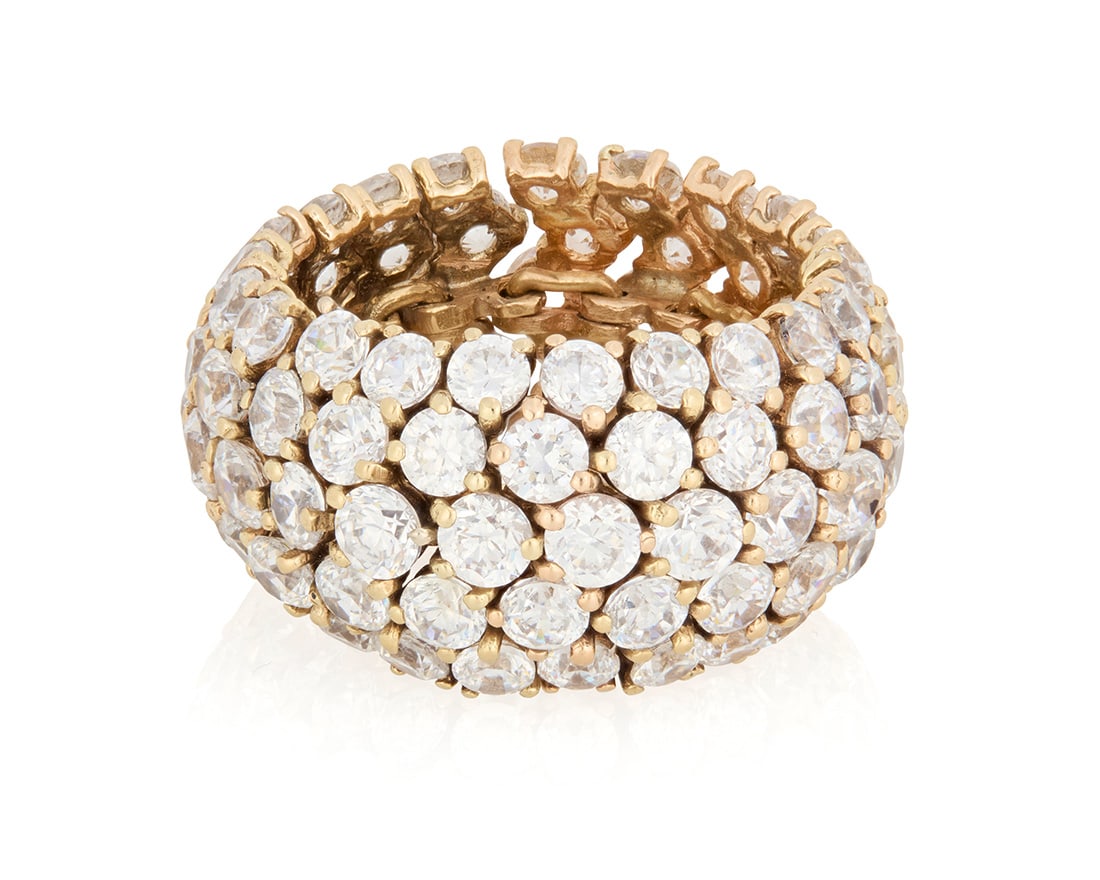 A 14K Gold and Diamond Eternity Band: A 14K Gold and Diamond Eternity BandFeaturing five graduated rows of round diamonds weighing approximately 13.20 carats in a flexible designSize: 8 1/215.2 grams grossProvenance:The Estate of Joa