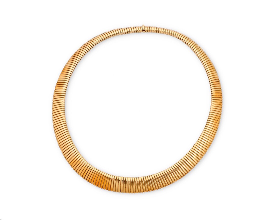 An 18K Gold Collar Necklace: An 18K Gold Collar NecklaceOf a graduated tubogas designLength: 15 in.65.0 grams grossProvenance:The Estate of Joanna Carson
