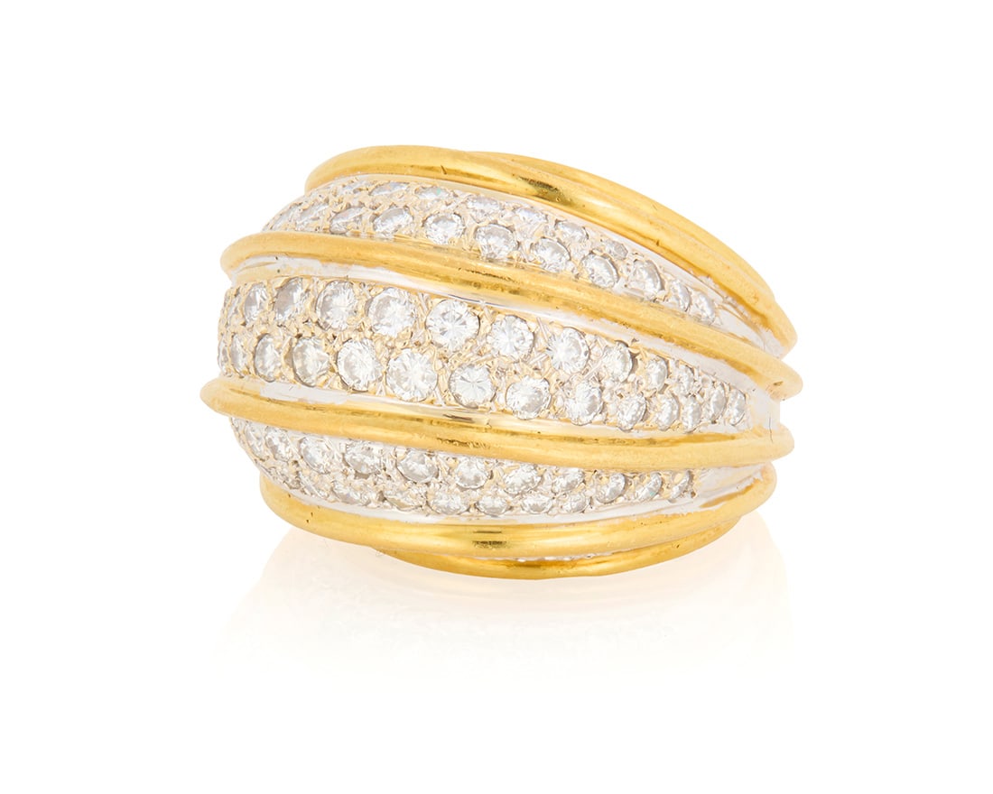 An 18K Bi-Color Gold and Diamond Ring: An 18K Bi-Color Gold and Diamond RingOf a domed design featuring five sections of round diamonds weighing approximately 3.40 caratsSize: 627.5 grams grossProvenance:The Estate of Joanna Carson