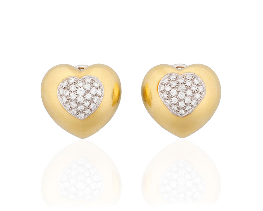 A Pair of 18K Gold and Diamond Heart Earclips: A Pair of 18K Gold and Diamond Heart EarclipsOf a heart-shaped high polish design centering fifty-town round diamonds weighing approximately 1.30 carats total2 piecesMeasures: 1 x 3/4 in.20.5 grams gr