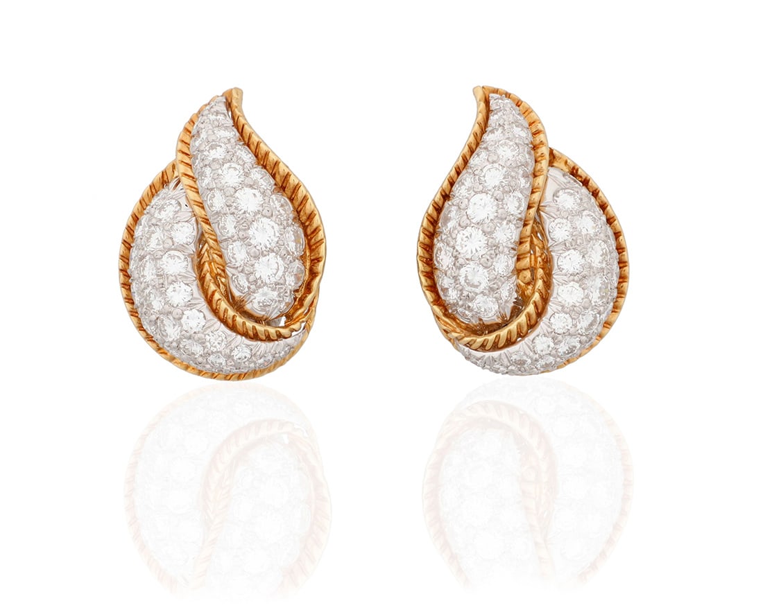 A Pair of Bi-Color Gold and Diamond Earclips: A Pair of Bi-Color Gold and Diamond EarclipsOf an organic design featuring textured gold edges set with graduated round diamonds weighing approximately 6.00 carats2 piecesMeasures: 1 1/4 x 3/4 in.20.0