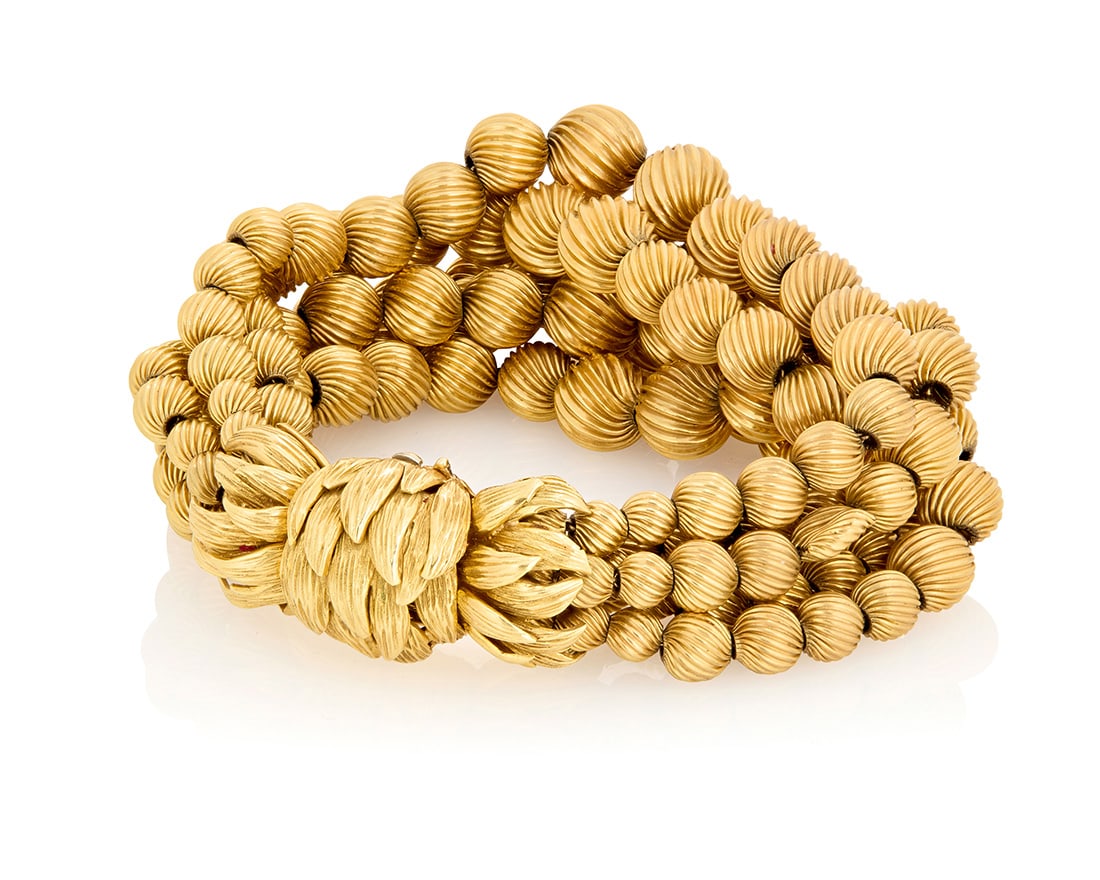 David Webb: An 18K Gold Bracelet: David Webb: An 18K Gold BraceletFeaturing six strands of graduated textured gold beads finished with a foliate motif clasp, signed WebbMeasures: 7 in.78.7 grams grossProvenance:The Estate of Joan