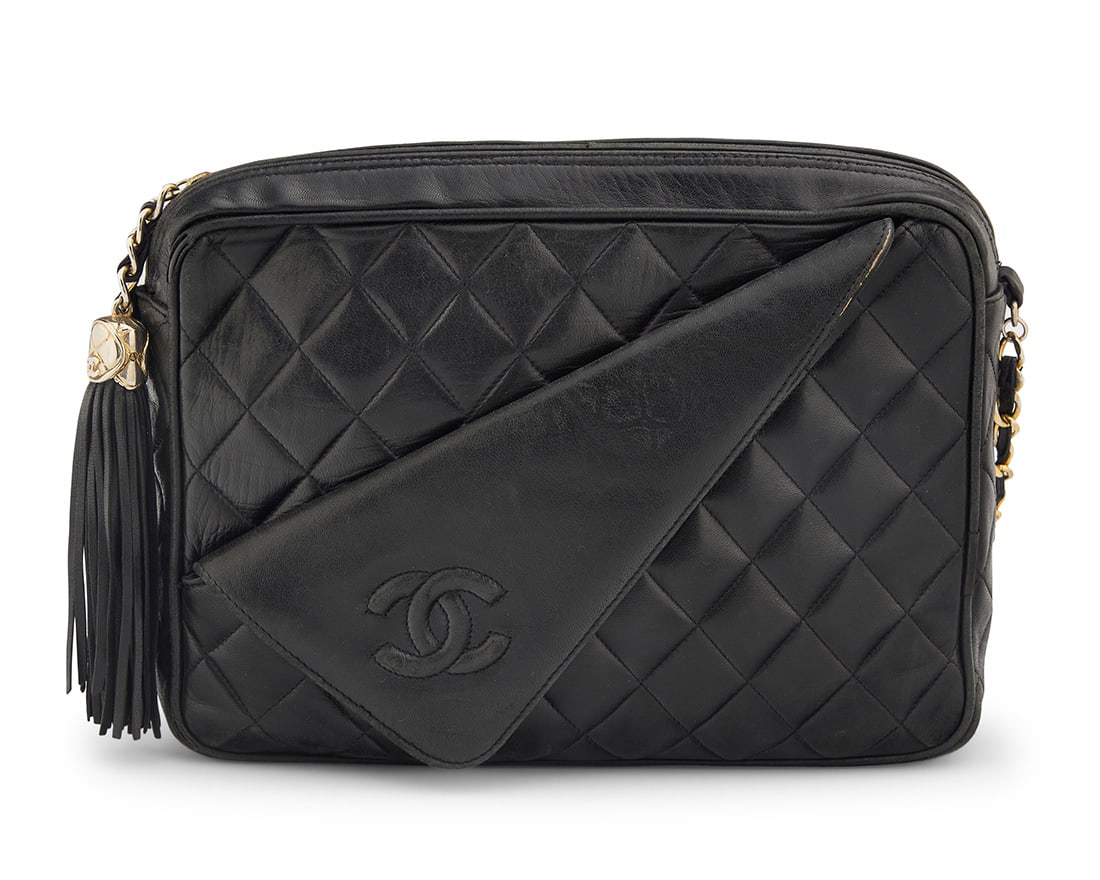 CHANEL: A Black Quilted Leather CC Collar Camera Bag: CHANEL: A Black Quilted Leather CC Collar Camera BagCirca 1980s-1990s; ItalyStamped to interior: Chanel / ® / Made in ItalyA rectangular soft leather bag with large fringe CC tassel, CC folded collar