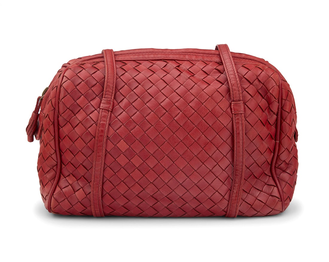 Bottega Veneta: A Vintage Red Intrecciato Woven Leather Shoulder Bag: Bottega Veneta: A Vintage Red Intrecciato Woven Leather Shoulder BagMarked to interior plaque: Bottega Veneta / Made in ItalyA bowling style zip-top soft bag with woven leather exterior, two long hand