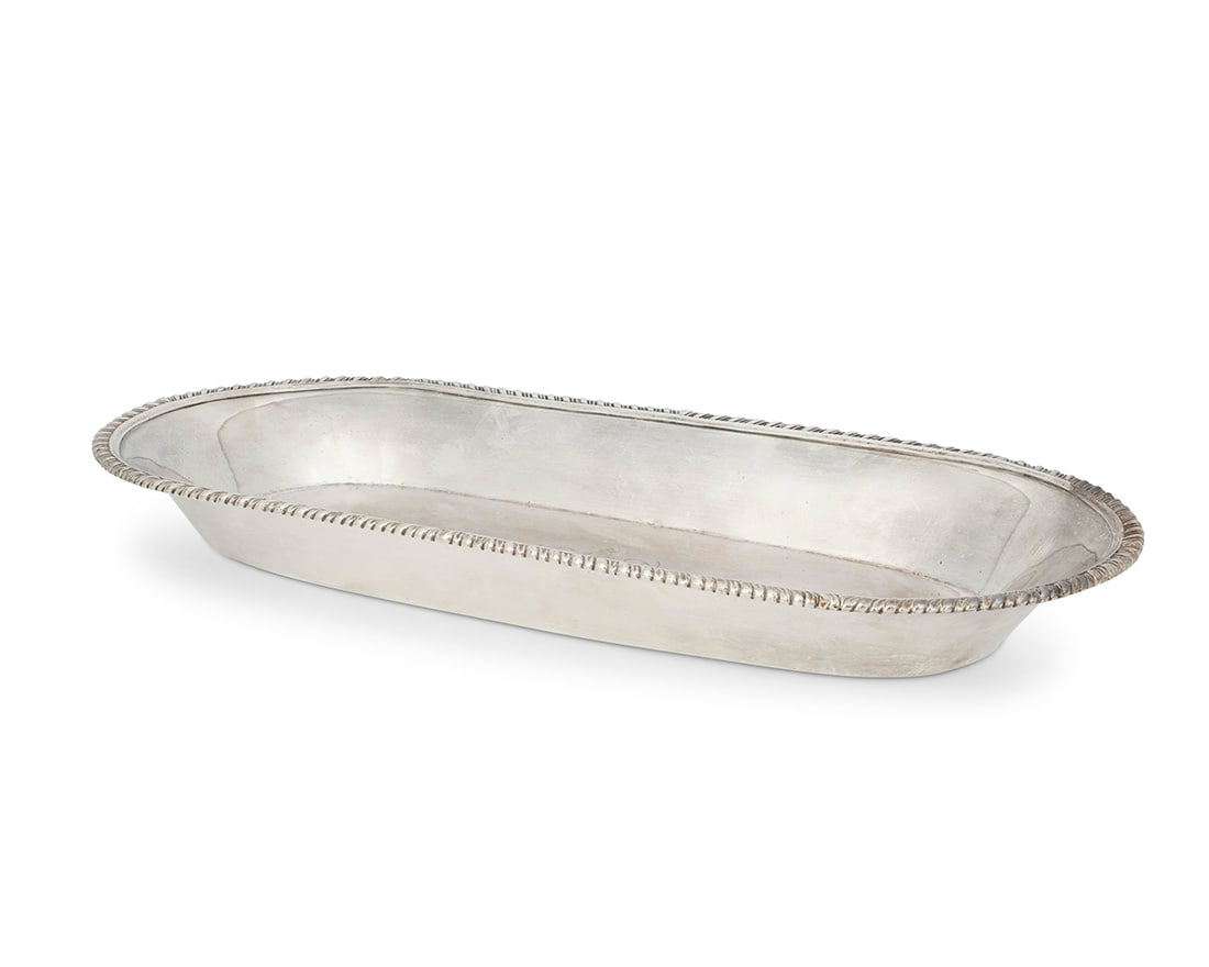 An English sterling silver bread bowl: An English sterling silver bread bowl London, 1854 With impressed standard, city, date letter, and indistinct maker's marks The oblong bowl centered by an armorial 1.625" H x 16" W x 7.75" D 29.4 oz.