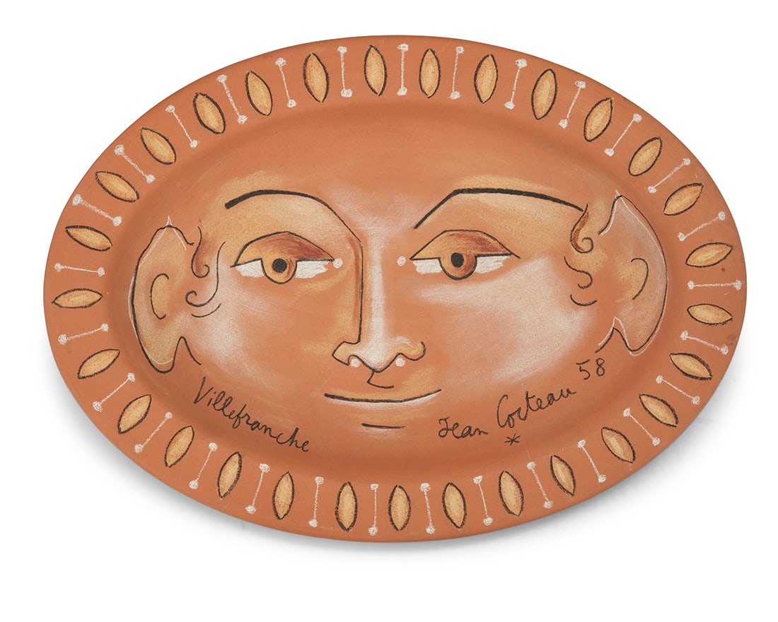 Jean Cocteau (1889-1963), "Visage ovale (G. 240)," 1958: Jean Cocteau (1889-1963) "Visage ovale (G. 240)," 1958 Terracotta charger with polychrome ceramic crayon Edition: 3/15 Signed, dated, and inscribed recto: Villefranche / Jean Cocteau [star cipher]