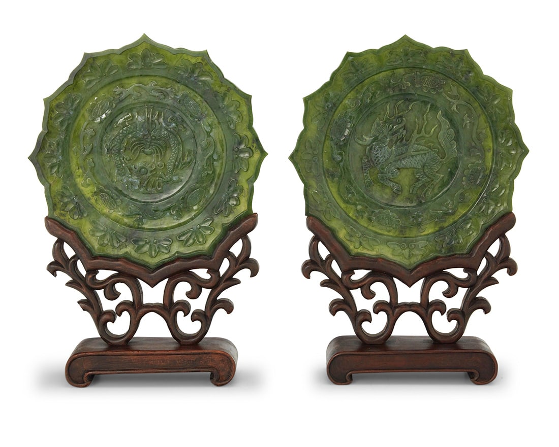 A pair of Chinese carved hardstone plates: A pair of Chinese carved hardstone plates 20th century Each bearing an apocryphal reign mark for Qianlong Period (1736-1795) Comprising one depicting a dragon and another depicting a qilin, each