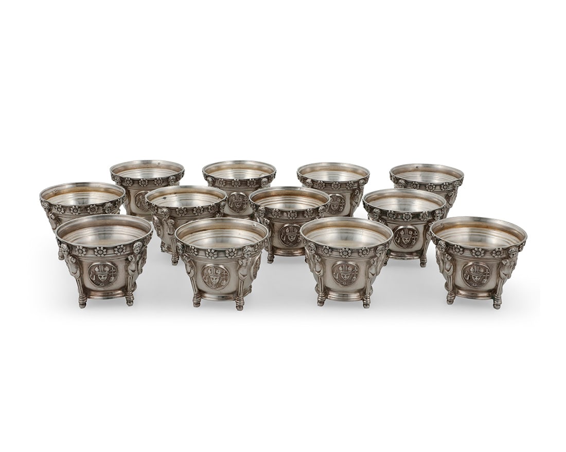 A set of twelve French silver open salts: A set of twelve French silver open salts20th centuryImpressed: M.G. [over three stars in a diamond lozenge]; XRF tested .940The rim with flowerheads over the body cast with four roundels enclosing the