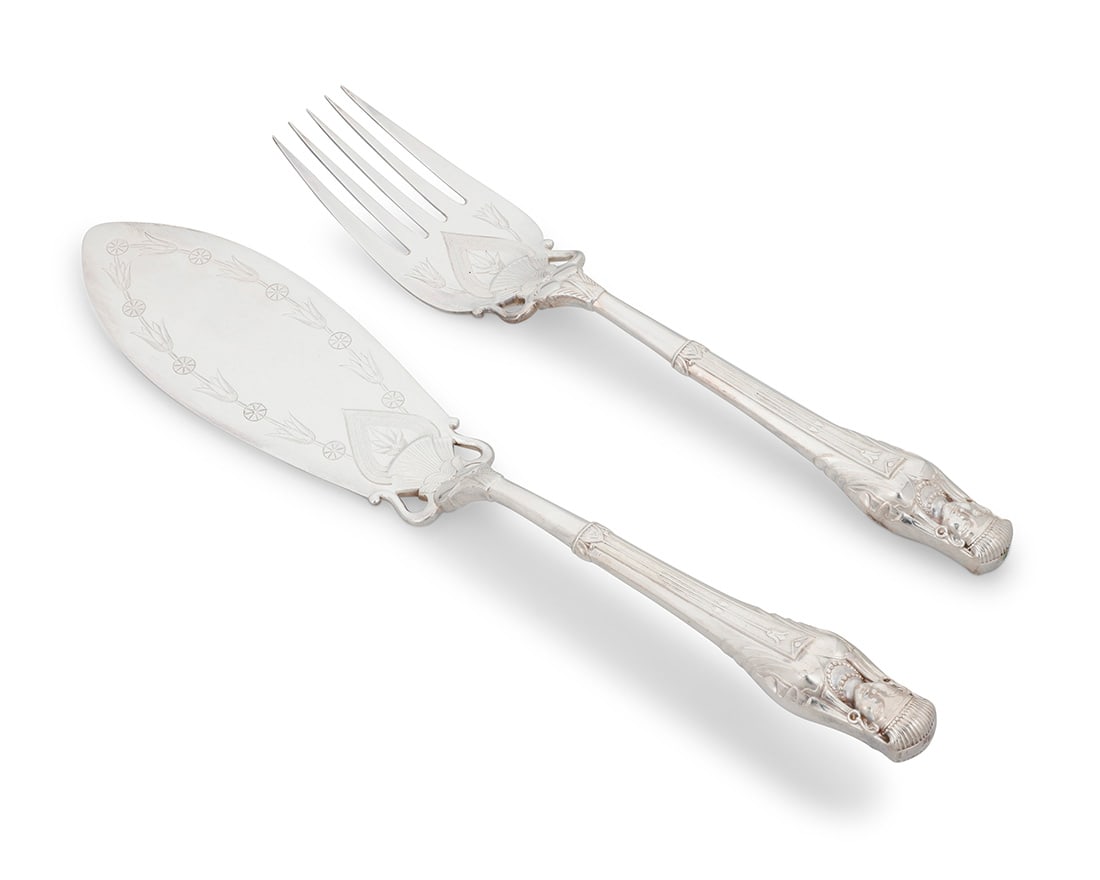 An Elkington silver plated fish serving set: An Elkington silver plated fish serving set1857Each impressed with factory marks and date markEach with Empire-style figural handle and chased with bellflower motifs, housed in a velvet-lined and leat
