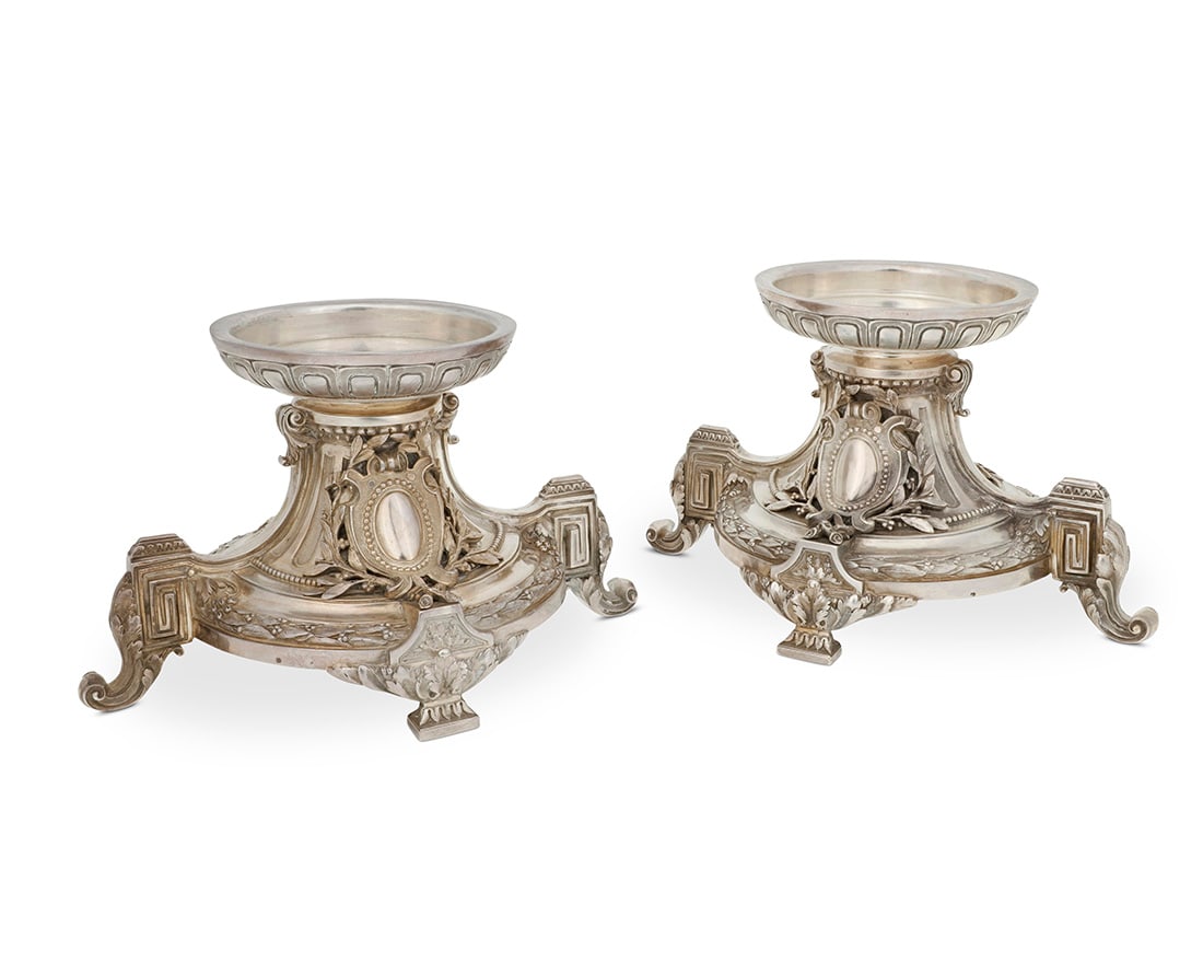 A pair of Neoclassical style silvered bronze center bowl bases: A pair of Neoclassical style silvered bronze center bowl bases Late 19th century Each with indecipherable marks 2 pieces Each: 5.5" H x 9.5" W x 6.75" D Provenance: The Estate of Joanna Carson