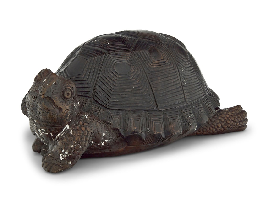 A patinated bronze figure of a turtle: A patinated bronze figure of a turtleCirca 1970sSigned: A. Tiot5.25" H x 12.75" W x 9.75" D Provenance:The Estate of Joanna Carson