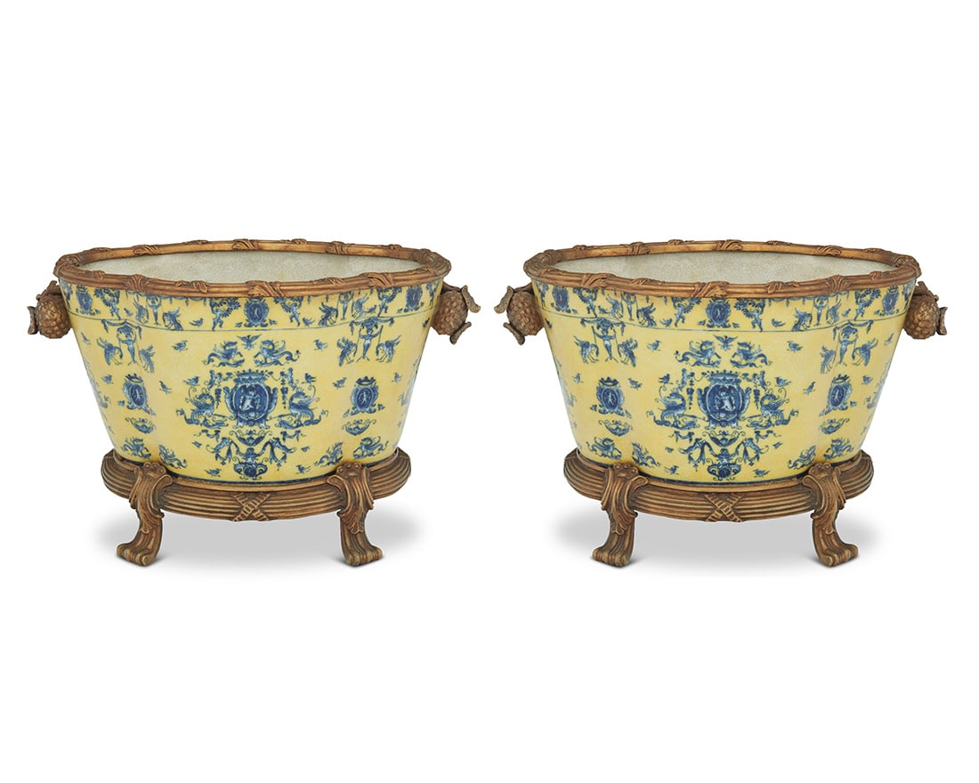 A pair of blue and yellow porcelain jardinieres: A pair of blue and yellow porcelain jardinieres21st centuryEach with blue underglaze maker's mark for United Wilson to undersideEach with gold-toned metal mounts2 pieces11.25" H x 18" W x 12.25" D Pro