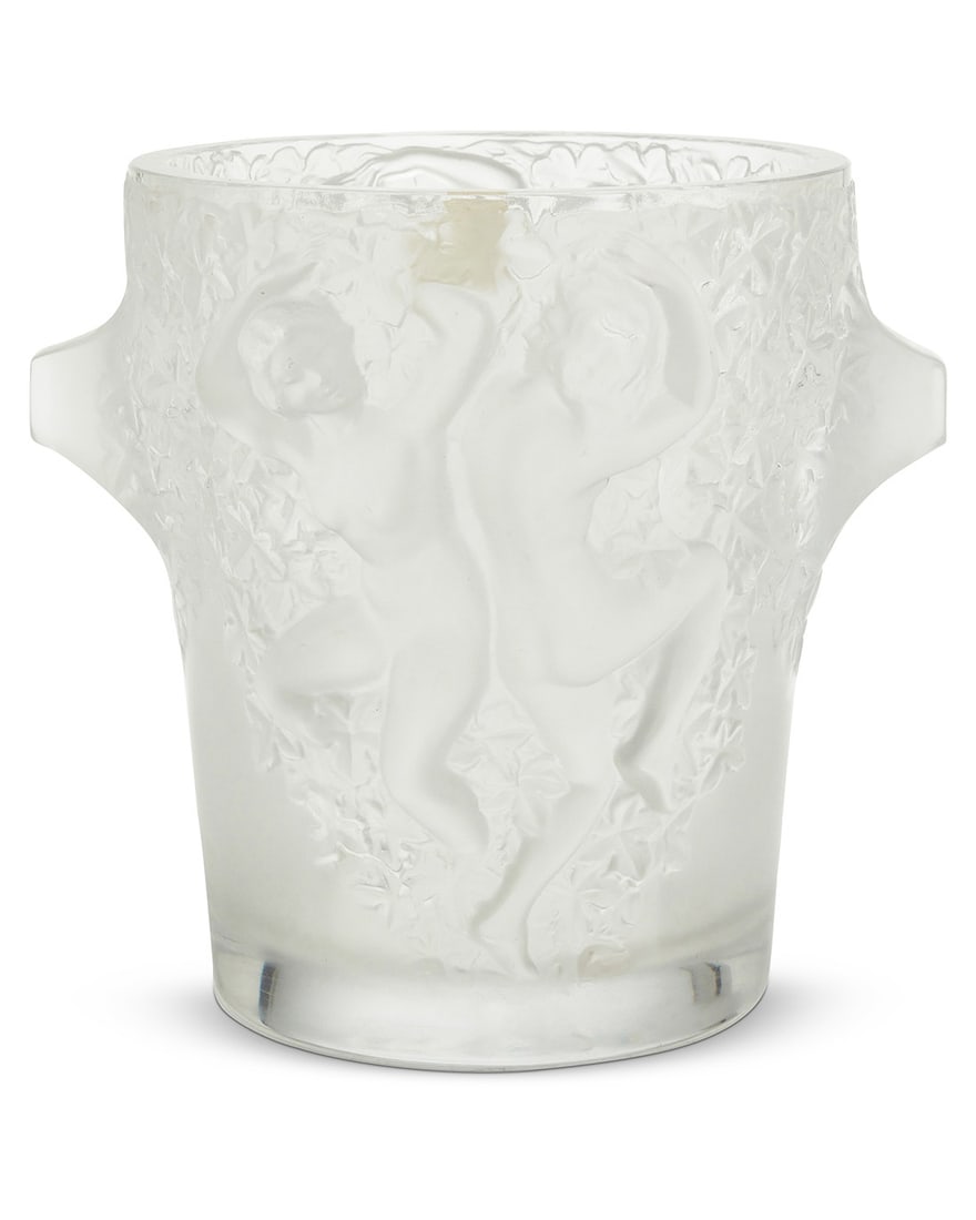A Lalique glass 'Bacchantes' ice bucket: A Lalique glass 'Bacchantes' ice bucketLate 20th/early 21st centuryEtched: Lalique ® / France; with partial factory label9.125" H x 10" W x 9.25" Dia. Provenance:The Estate of Joanna Carson