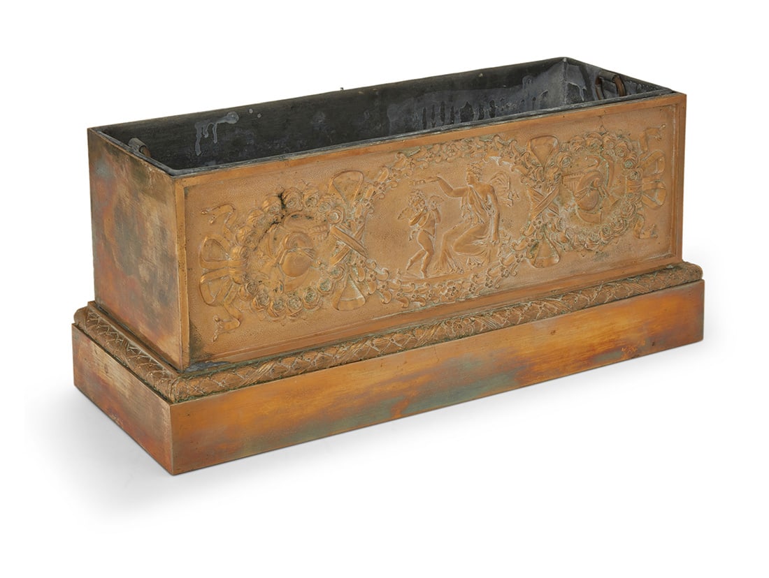 A French gilt bronze jardiniere: A French gilt bronze jardiniereLate 19th centuryOne side with a frieze depicting classical figures surrounded by wreaths and ribbons in relief, with a metal insert5.5" H x 11.5" W x 4.5" D Provenance: