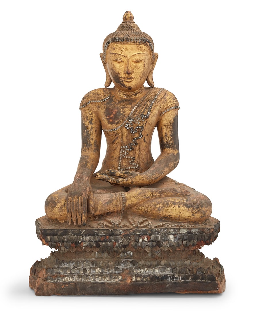 A Southeast Asian carved giltwood Buddha: A Southeast Asian carved giltwood BuddhaRattanakosin Period (1782-1932)With hands in Bhumisparsha mudra, decorated with inset glass accents, raised on a double lotus base25" H x 17.75" W x 9.75" D Pro