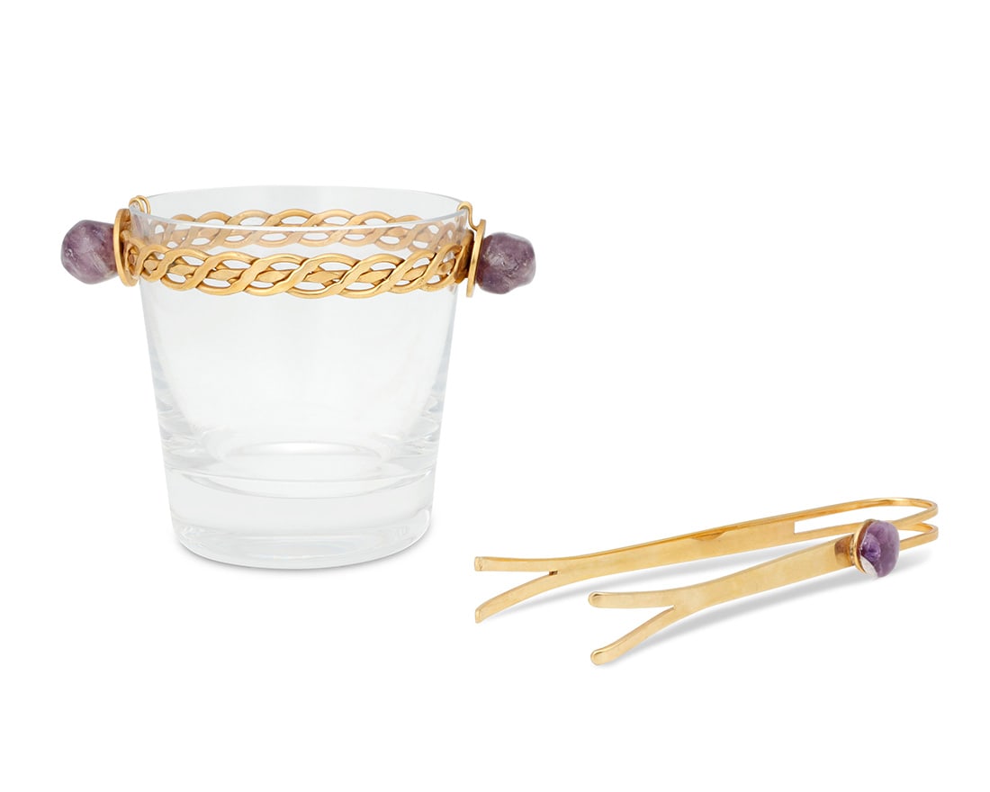 A Baccarat gilt metal mounted glass ice bucket and tongs: A Baccarat gilt metal mounted glass ice bucket and tongsLate 20th/early 21st centuryBucket with etched factory markEach mounted with amethyst2 piecesBucket: 4.375" H x 6" W x 4.375" D; Tongs: 6.875" L