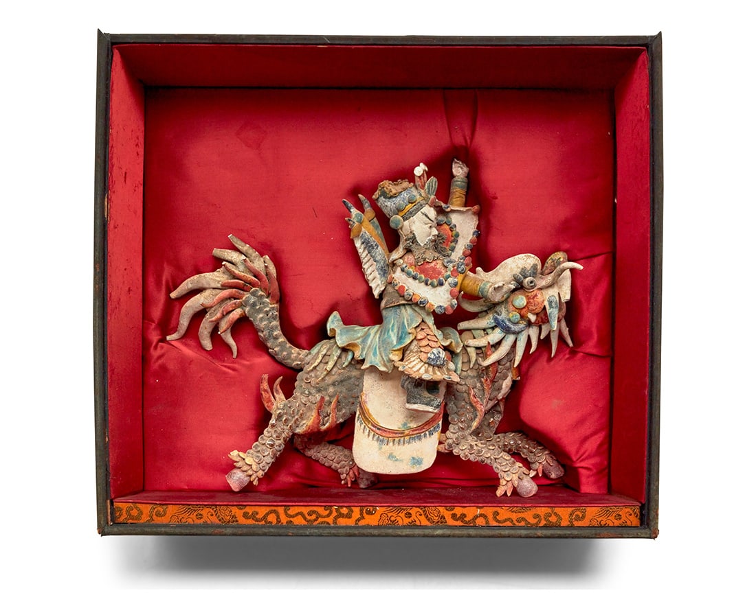 A Chinese polychrome terracotta roof tile warrior: A Chinese polychrome terracotta roof tile warrior Qing Dynasty (1644-1912) or later Set in a custom padded wood shadowbox Figure: 11.75" H x 14.5" W x 4.5" D approximately; Box: 15" H x 16.5" W x