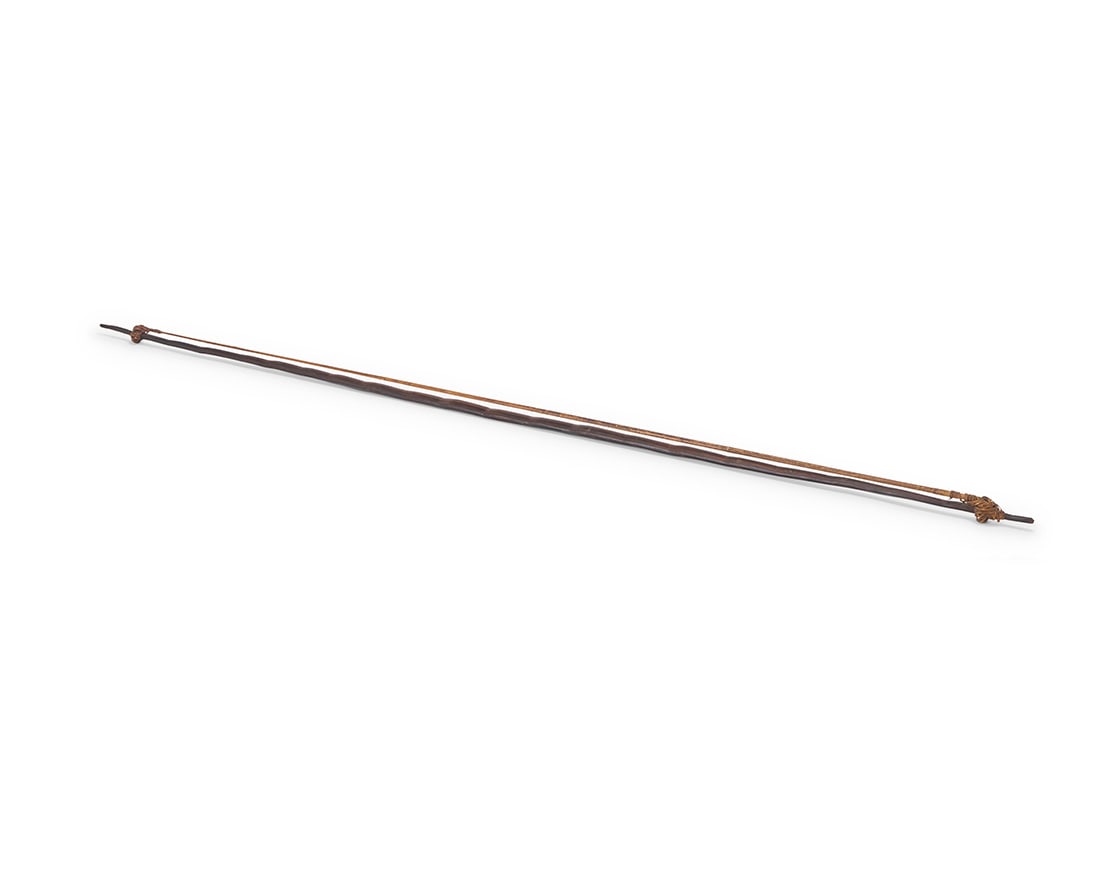 An Oceanic carved wood bow: An Oceanic carved wood bow 20th century With reeded bowstring 69" L