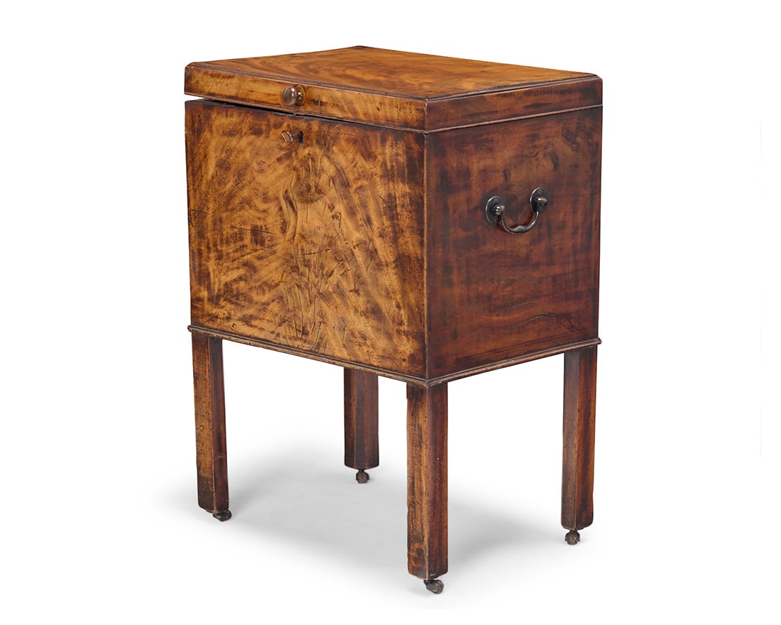 A George III mixed wood cellarette: A George III mixed wood cellarette Late 18th/early 19th century The locking hinged top opening to reveal an interior fitted with six metal-lined inserts 26" H x 19" W x 14.75" D