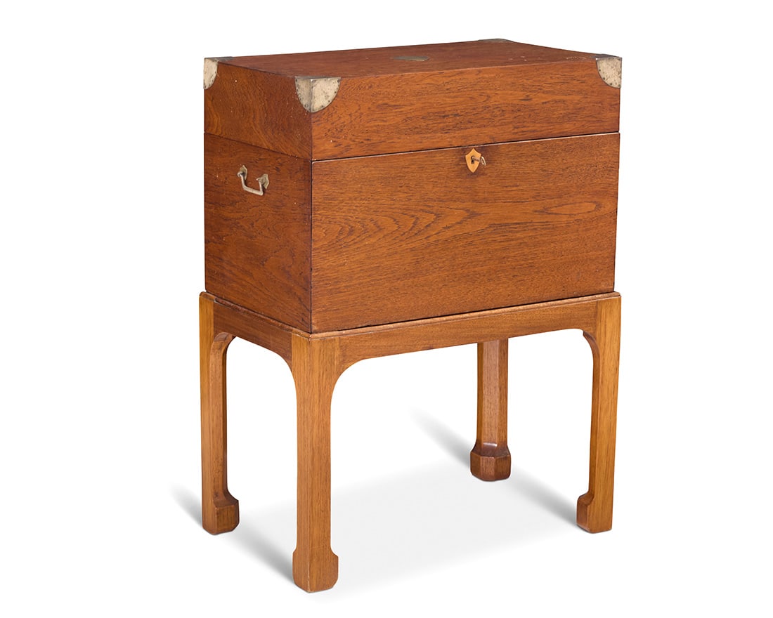 A George III style mixed wood travel desk on later stand: A George III style mixed wood travel desk on later stand 20th century Monogrammed: P W The metal-clad box with opposed handles and locking drop-front opening to reveal two drawers with felt lining,