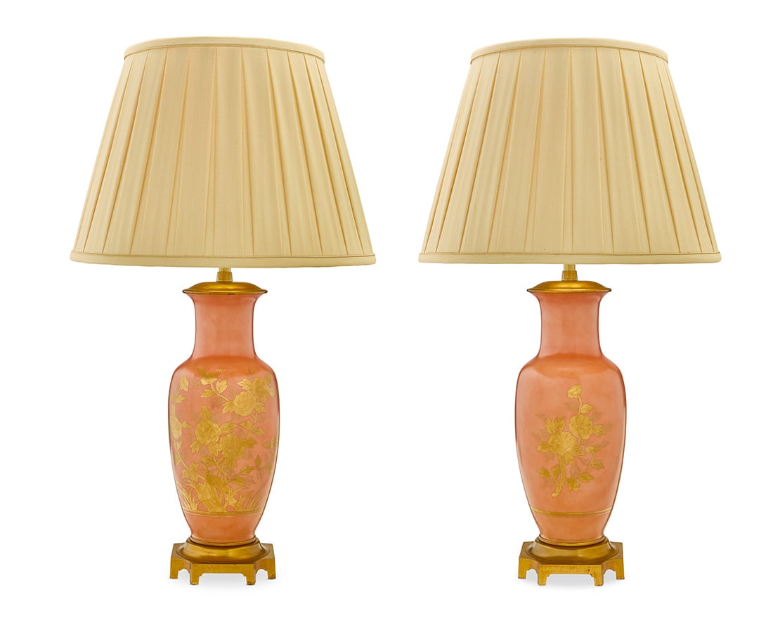 A pair of gilt porcelain lamps: A pair of gilt porcelain lampsMarbro Lamp Company, mid-20th centuryUnderside of foot impressed in relief: MARBROThe gilt-decorated matte salmon-glazed bodies each mounted as a two-light table lamp, wi