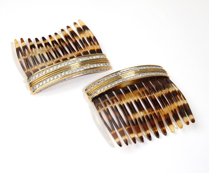 A pair of diamond and gold hair combs, Cartier: Signed Cartier, 10949 and 10950, 18K gold and platinum-trimmed set with 140 full-cut diamonds totaling approximately 4.75 cts, graded G-H color and VS clarity, 2'' x 1 7/8'', est: $3000/5000
