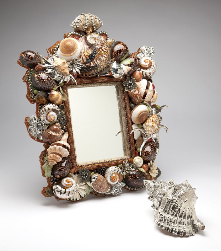 A shell & crystal mirror with silver conch shell