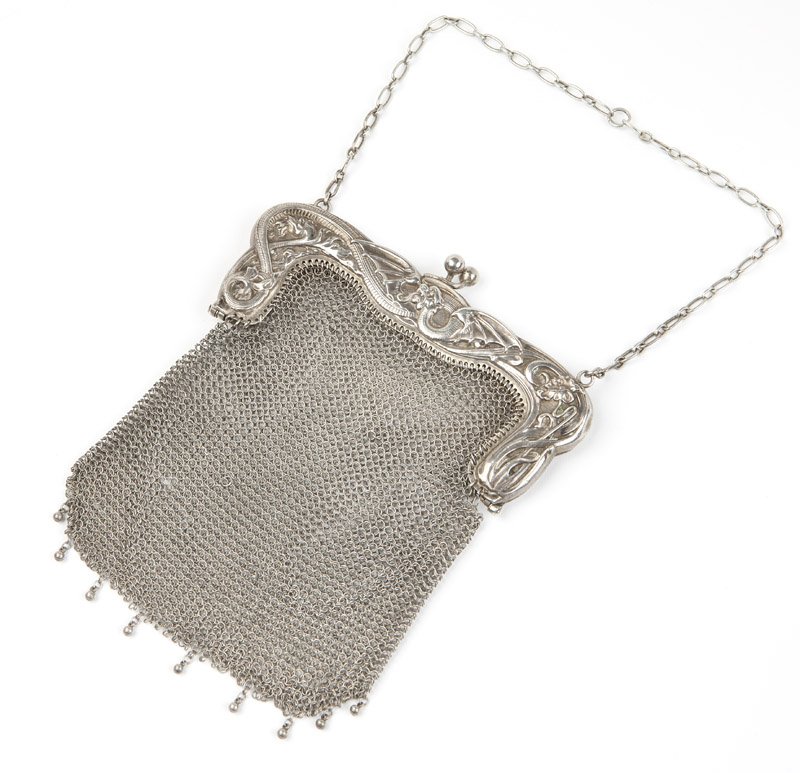 A silver mesh purse with dragon motif
