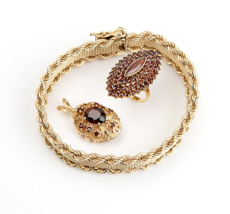 A collection of stone and gold jewelry
