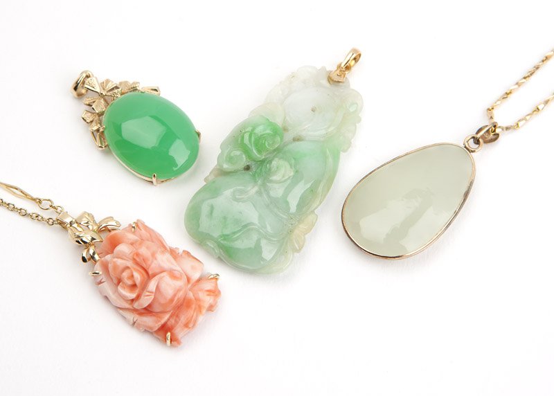 A collection of stone and gold pendants