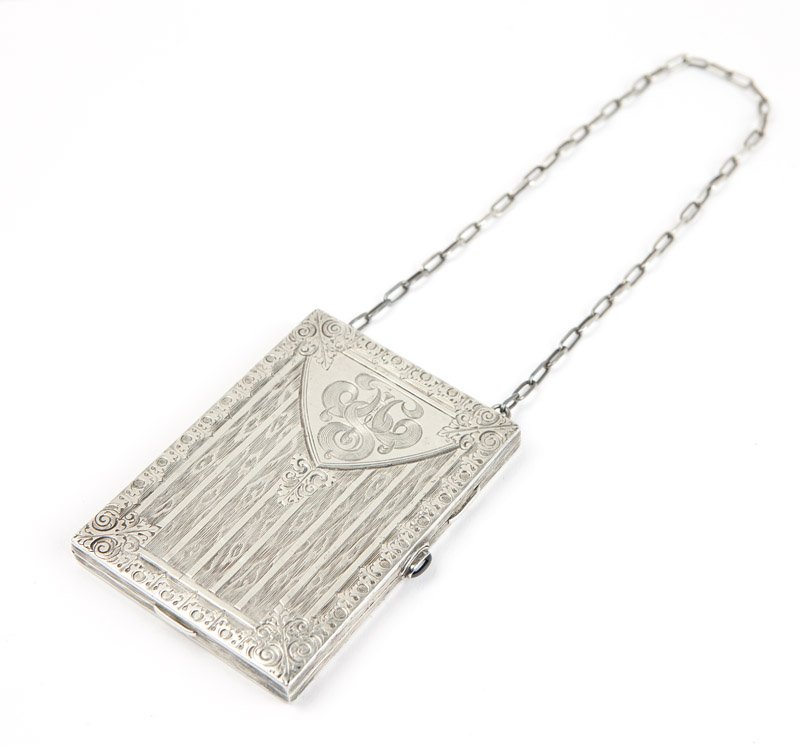 A silver vanity with sapphire closure and chain