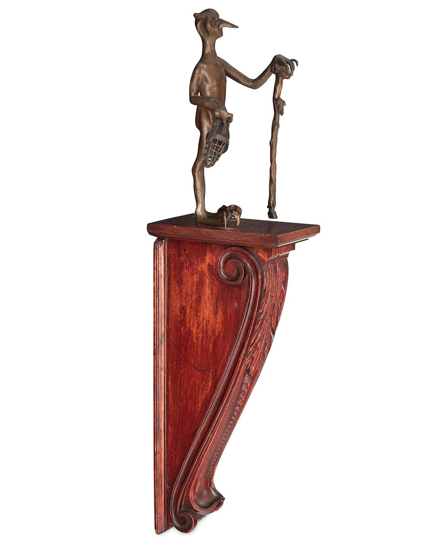 Eric Aman (20th/21st Century), Fantastical figure: Eric Aman (20th/21st Century) Fantastical figure Patinated bronze sculpture on a wood wall bracket Unmarked Figure: 12" H x 6" W x 6" D; Wood: 20.25" H x 5.25" W x 8.875" D