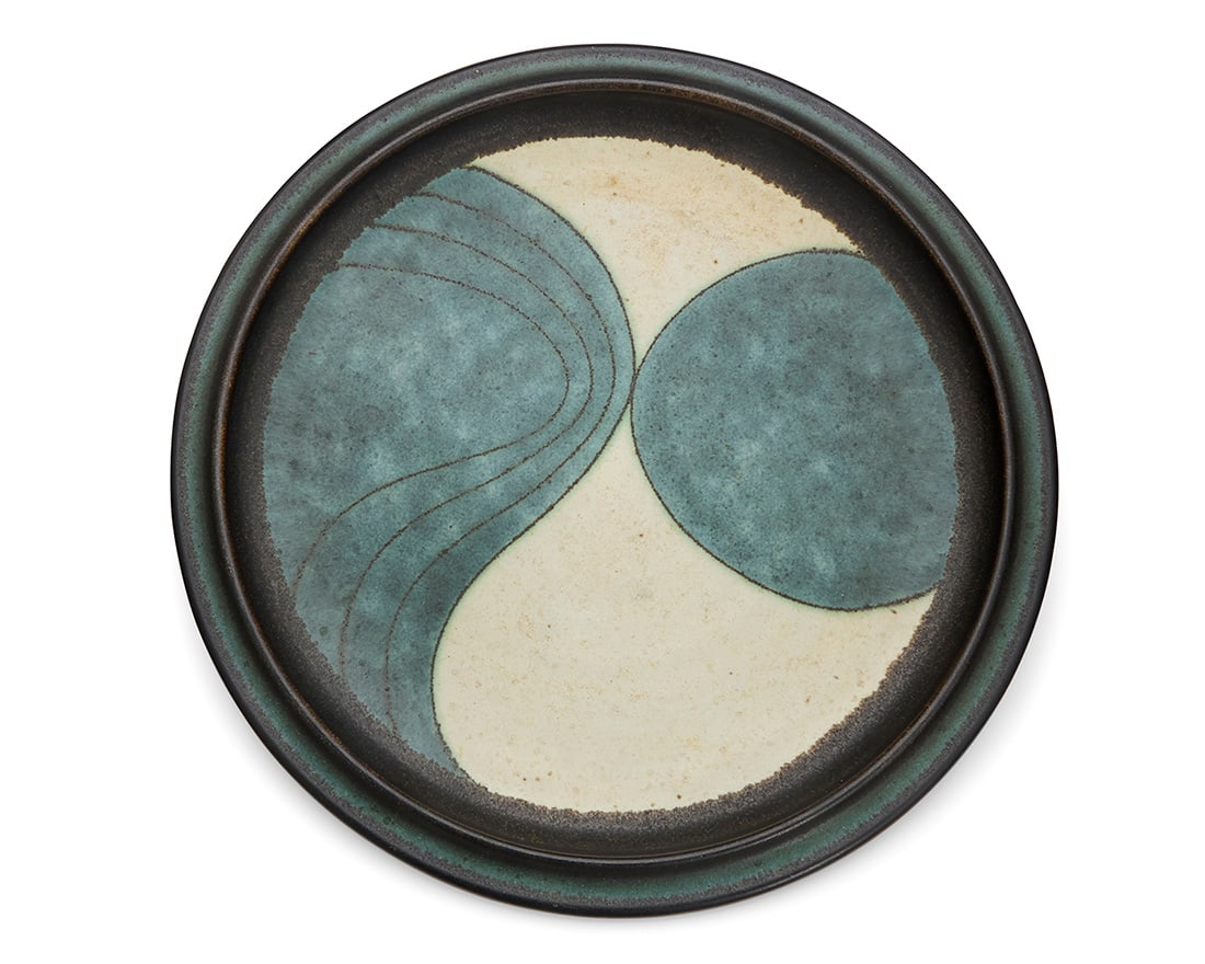 Harrison McIntosh (1914-2016), A glazed stoneware plate, mid-20th century: Harrison McIntosh (1914-2016)A glazed stoneware plate, mid-20th centuryImpressed with potter's chop mark: HM; applied paper label to the underside: Handthrown Stoneware / Harrison McIntosh / Claremont