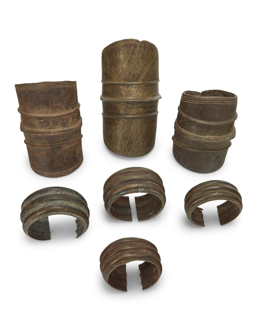 A group of Ekonda brass anklets and West African cuffs: A group of Ekonda brass anklets and West African cuffs19th/20th centuryComprising three anklets and four cuff bracelets7 piecesLargest anklet: 10" H x 5.5" W x 6" D; Smallest cuff: 2.375" H x 4.25 W x