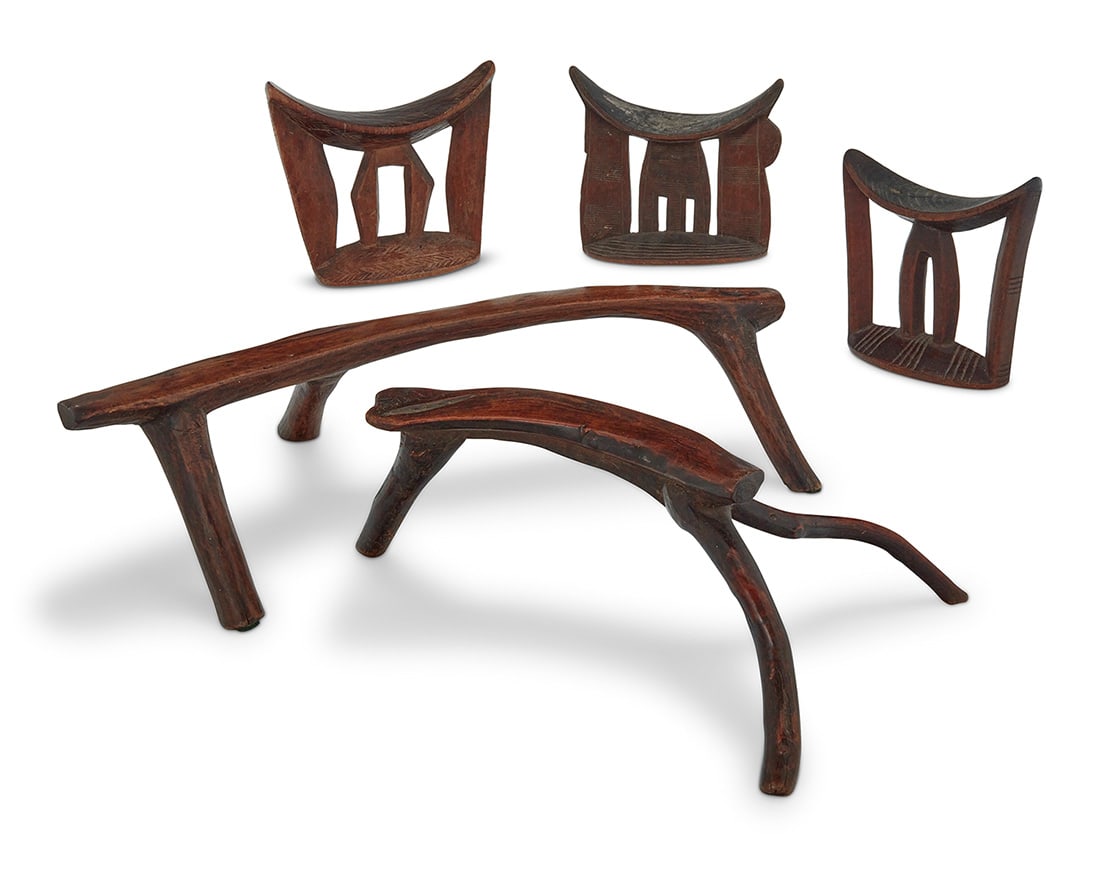 Five East African carved wood headrests: Five East African carved wood headrests20th centuryComprising three with incised details and two natural wood5 piecesLargest: 6.125" H x 22.5" W x 13.125" D Provenance:Collection of Stefan Lawrence, f
