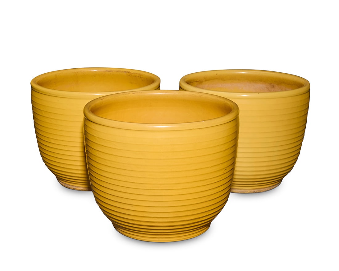 Three Bauer yellow glazed pottery ringware planters: Three Bauer yellow glazed pottery ringware planters Circa 1930s Each incised to underside: 111 3 pieces Each: 13.25" H x 16.375" Dia.