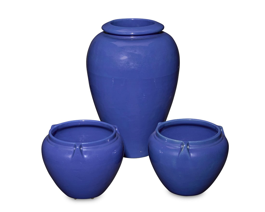 A pair of Bauer blue glazed pottery hanging baskets and an oil jar: A pair of Bauer blue glazed pottery hanging baskets and an oil jar Circa 1930s Each unmarked 3 pieces Pair: 8.25" H x 10.5" Dia.; Oil jar: 19.25" H x 13.25" Dia. Literature: Similar illustrated