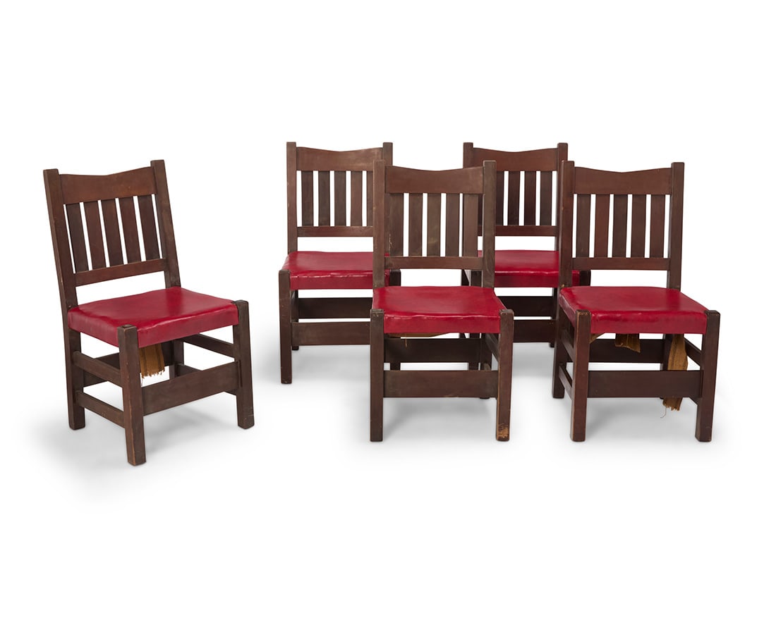 A group of five Gustav Stickley V back side chairs, no. 1305: A group of five Gustav Stickley V back side chairs, no. 1305 Circa 1902 Each stamped with red joiner's compass mark Each with five-slat back above later red leather-wrapped seat 5 pieces Each: 36" H