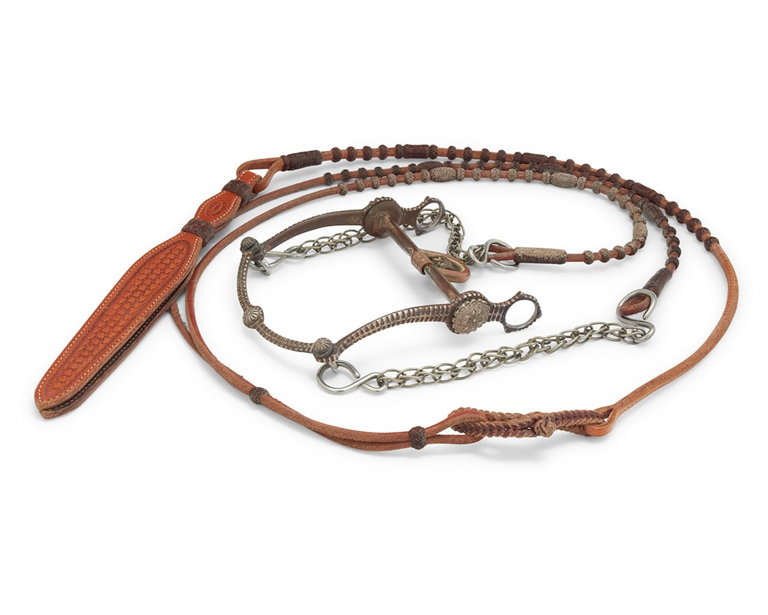 An E.G. Field sterling silver and mixed metal bit & California Classics hide reins: An E.G. Field sterling silver and mixed metal bit & California Classics hide reinsEarly 21st centuryStamped to bit: E.G. Fields / Stamped to reins: California Classics / Maker / Templeton, CAComprisin